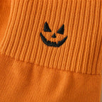 Macro of the embroidered pumpkin and ribbed cuff seam